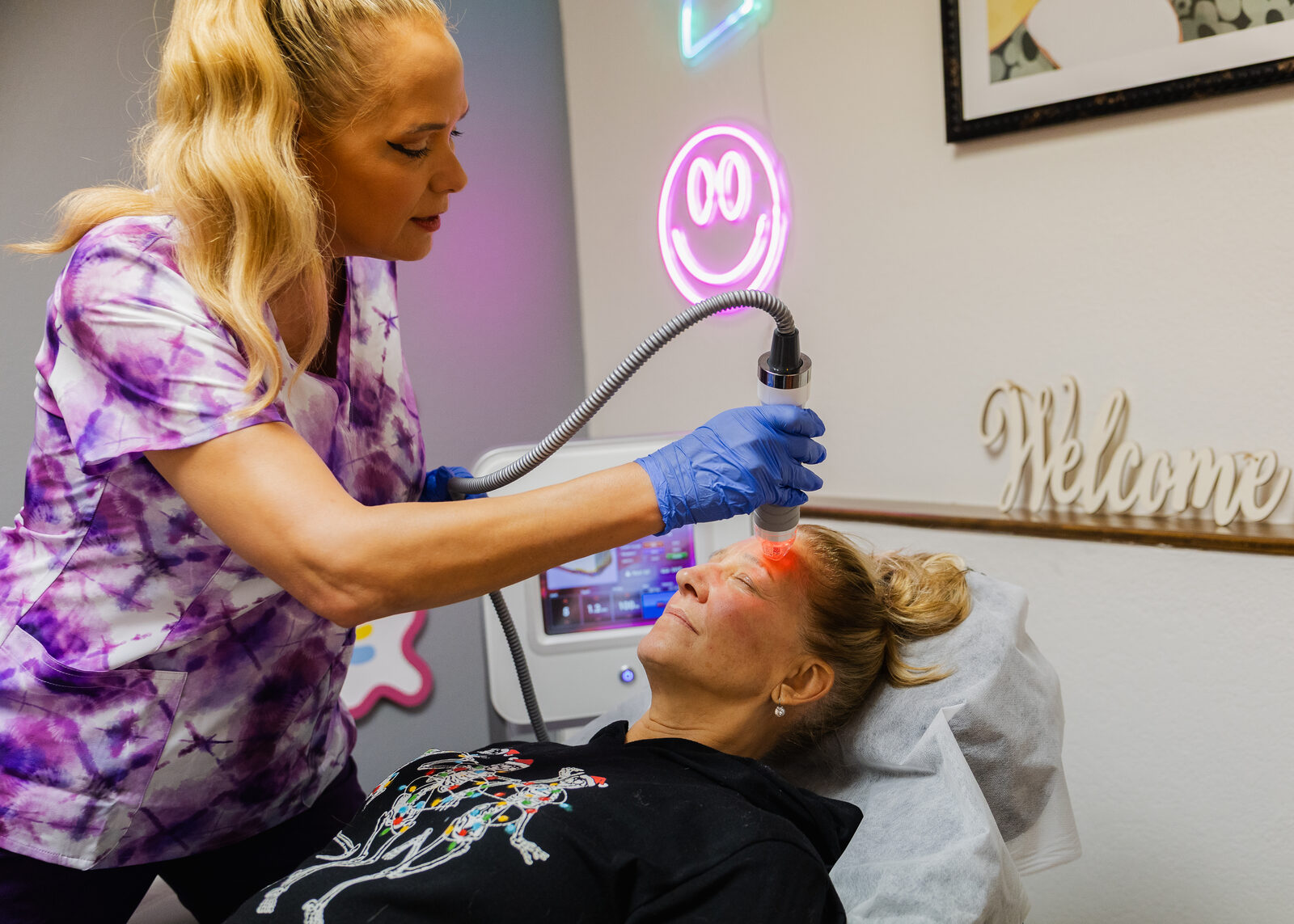 Gail treating a client's forehead with the Vivace RF system