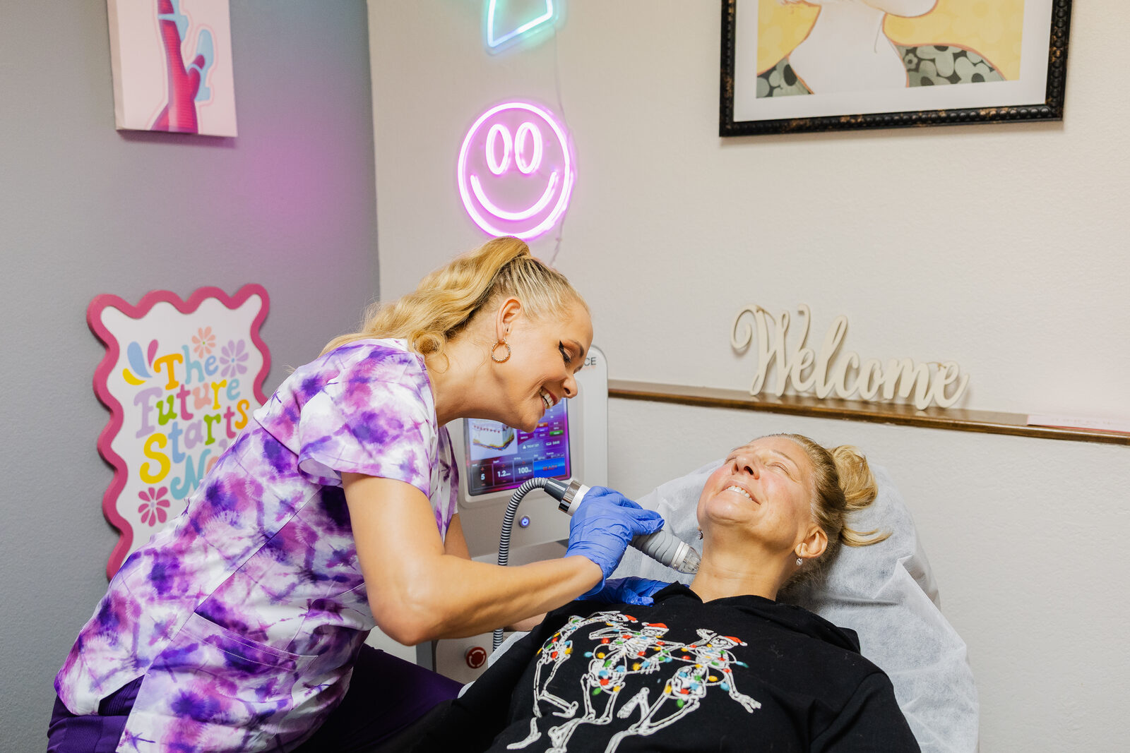 Gail laughing with a happy client during a treatment